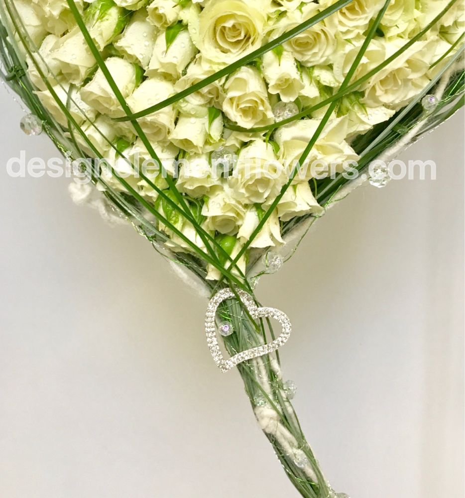 Bottom Brides Heart Bouquet created with Bear Grass and White Spray Rose , White Roses finished with a Diamante Heart