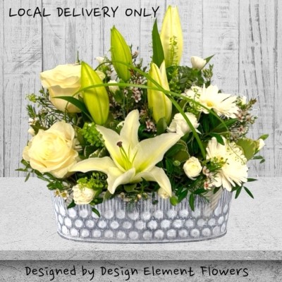 Elegant White Zinc Arrangement hand delivered in surrounding areas like Manchester , Salford , Eccles , Worsley , Partington, Rixton, Irlam , Cadishead , Urmston 