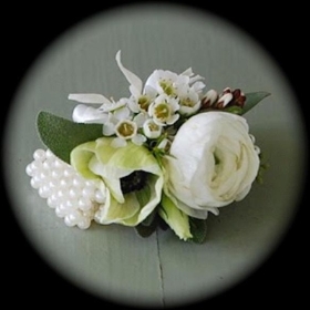 Ranunculous and Wax Flower Wrist Corsage hand delivered in our local areas like Irlam , Cadishead , Monton, Worsley, Salford , Greater Manchester, Peel Green , Sale , Partington, Walkden 
