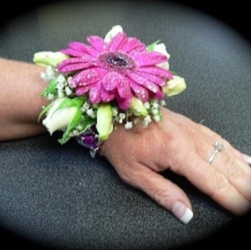 Wrist Corsage with Cerise Mini Gerbera and Eustoma Flower hand delivered locally around Salford , Manchester , Eccles , Monton, Swinton, Irlam , Cadishead , Worsley , Urmston , Greater Manchester 